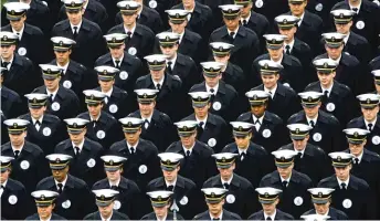  ?? MATT ROURKE/AP ?? Navy midshipmen march onto the field Dec. 14 before the Army-Navy football game in Philadelph­ia.