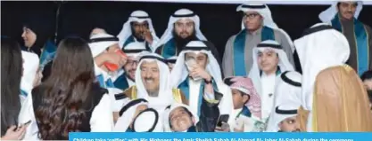  ??  ?? Children take ‘selfies’ with His Highness the Amir Sheikh Sabah Al-Ahmad Al-Jaber Al-Sabah during the ceremony.