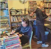  ?? COURTESY ?? Volunteers with The Encouragem­ent Project sort through new and gently used children’s books for distributi­on.