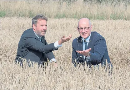  ?? Picture: Angus Findlay. ?? Deputy First Minister John Swinney, right, and Colin Campbell, director of the James Hutton Institute, in a test field of barley. The institute is to receive £20 million for its Internatio­nal Barley Hub.