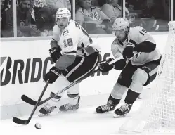  ?? THE ASSOCIATED PRESS ?? Calgary Flames center Matt Stajan moves the puck ahead of Nashville Predators right wing Craig Smith in the first period of Tuesday’s game in Nashville.