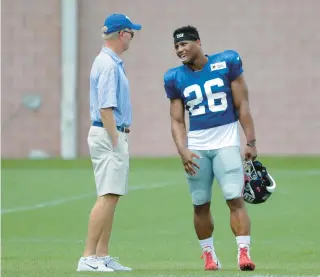  ?? JULIO CORTEZ/AP ?? Giants owner John Mara, left, talks with running back Saquon Barkley during training camp Aug. 2, 2018, in East Rutherford, New Jersey.