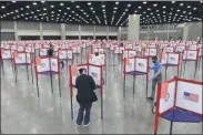  ?? TIMOTHY D. EASLEY ?? FILE - In this June 23, 2020, file photo voting stations are set up in the South Wing of the Kentucky Exposition Center for voters to cast their ballot in the Kentucky primary in Louisville, Ky. The November election is coming with a big price tag as America faces the coronaviru­s pandemic. The demand for mail-in ballots is surging, election workers are in need of training and polling booths might have to be outfitted with protective shields.