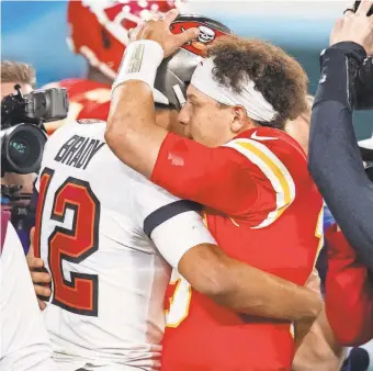  ?? MARK J. REBILAS/USA TODAY SPORTS ?? Tom Brady and Patrick Mahomes hugged at midfield after the Bucs beat the Chiefs in Super Bowl 55.