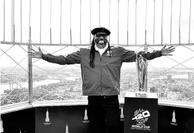  ?? COURTESY OF ICC-CRICKET ?? Chris Gayle displays the ICC Men’s T20 World Cup Trophy atop the Empire State Building in New York.