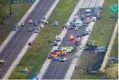  ?? ANDREW WEST/THE NEWS-PRESS VIA AP ?? Emergency officials work the scene of a small-plane crash on Interstate 75.