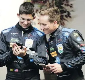  ?? — THE ASSOCIATED PRESS FILES ?? Jordan Taylor, left, and Renger Van Der Zande laugh when they’re called guinea pigs in a study that sees them rigged up with sensors to measure various body functions.