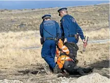  ?? JOHN BISSET/STUFF ?? A protester is dragged away from a demonstrat­ion at a large dairy farm developmen­t in the Mackenzie Country.