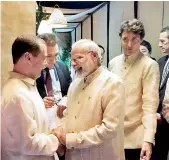  ?? — PTI ?? Prime Minister Narendra Modi talks to Russian Premier Dmitry Medvedev as Canadian PM Justin Trudeau walks past, in Manila on Sunday.