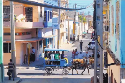  ?? TOM SHARPE/FOR JOURNAL NORTH ?? Horse-drawn carriages may appear to be something for tourists, but in Holguín, Cuba — a “sister city” of Santa Fe — they are more likely to be used by locals.