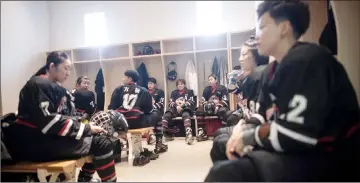  ?? — AFP photo ?? Harbin women’s ice hockey team resting in the dressing room at half time.