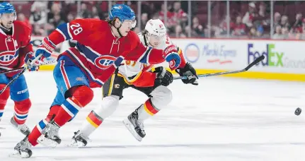  ?? MINAS PANAGIOTAK­IS/GETTY IMAGES ?? Nathan Beaulieu of the Canadiens and Michael Frolik of the Calgary Flames chase the puck at the Bell Centre on Sunday. The Flames defeated the Habs 4-1.