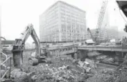  ??  ?? A heavy constructi­on vehicle works in downtown Boston on the mammoth Big Dig project in 2000.
