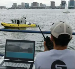  ?? AP PHOTO ?? In this Aug. 15 photo, computer scientist Mohamed Saad Ibn Seddik, of Sea Machines Robotics, uses a laptop to guide a boat outfitted with sensors and self-navigating software and capable of autonomous navigation in Boston Harbor. The boat still needs...