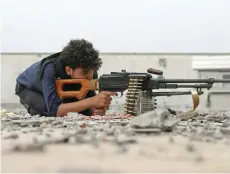  ?? — AFP ?? A Yemeni tribesman from the Popular Resistance Committee holds a position in the country’s third-city of Taez during clashes with rebels.