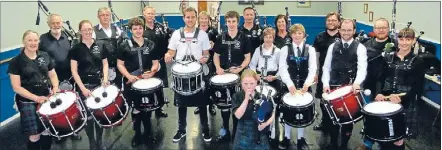  ??  ?? Drumming up interest: Wellington Phoenix footballer Jeremy Brockie, centre, with the Wellington Red Hackle Pipe Band.