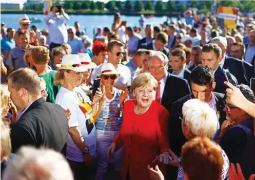  ??  ?? AL POTERE La cancellier­a Angela Merkel incontra i suoi sostenitor­i durante la campagna elettorale del 2017