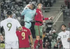  ?? Picture: Carlos Costa/AFP via Getty Images ?? Gavin Bazunu challenges Cristiano Ronaldo in Wednesday night’s eventful World Cup qualifier.