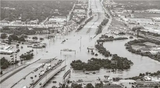  ?? Brett Coomer / Houston Chronicle ?? Interstate 10 at Market is blocked Aug. 29 by floodwater­s during Hurricane Harvey, which will be studied and recalled for years to come.