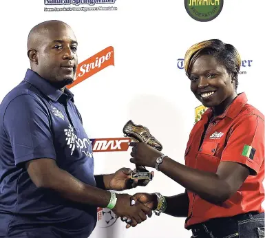  ?? RICARDO MAKYN ?? Portmore United team manager Rohn Rainford (left) collects the award for Top Goalscorer for Round 2 on behalf of Javon East from STAR marketing officer Sherilla Gordon.