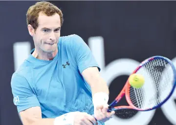  ?? — AFP photo ?? Andy Murray of Britain hits a return during a practice session with Australia's Alex de Minaur in Brisbane on December 30, 2018, ahead of Brisbane Internatio­nal tennis tournament.