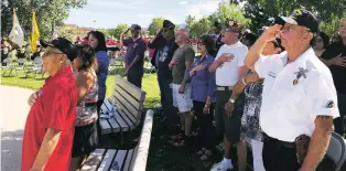  ?? ARI BURACK/THE NEW MEXICAN ?? Veterans salute during the singing of the national anthem at Saturday’s Purple Heart Recognitio­n Ceremony in Santa Fe.