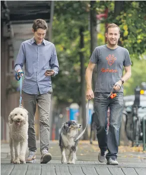  ?? ARLEN REDEKOP/PNG ?? Willson Cross, left, and Paul Ratchford walk Brydie and Juno in Vancouver last year. Cross and Ratchford are co-founders of GoFetch, a startup that just closed a $1.4 million seed-funding round, with all money raised from B.C.-based investors.