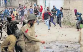  ?? WASEEM ANDRABI/HT ?? Protesters hurl stones at police and paramilita­ry forces in Srinagar on Wednesday. Clashes were also reported from Shopian, Pulwama, Kulgam, Anantnag and Bandipora districts.