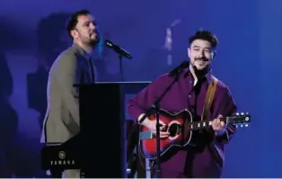  ?? AP PHOTO/CHRIS PIZZELLO ?? Ben Lovett, left, and Marcus Mumford of Mumford & Sons perform Friday at MusiCares Person of the Year honoring Berry Gordy and Smokey Robinson at the Los Angeles Convention Center.