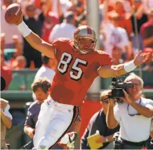  ?? Frederick Larson / The Chronicle 1997 ?? Former 49ers tight end Greg Clark celebrates after scoring his first pro TD in the first quarter against the Rams in 1997.