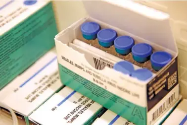  ?? AP PHOTO/SETH WENIG ?? Vials of measles, mumps and rubella vaccine sit in a cooler in 2019 at the Rockland County Health Department in Pomona, N.Y.