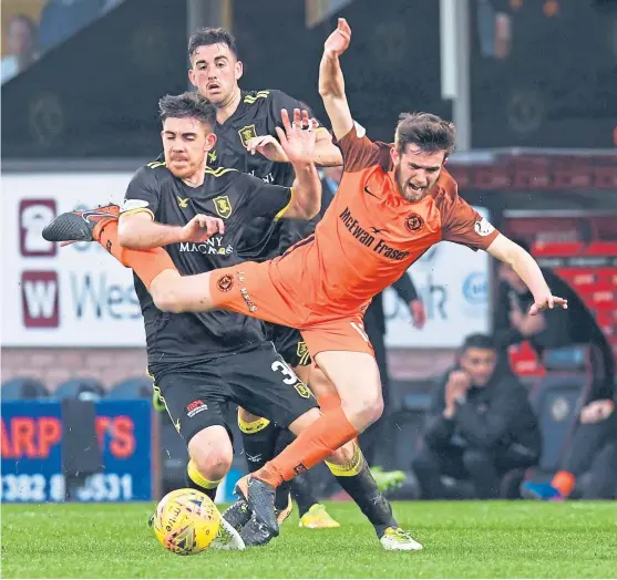  ?? Picture: SNS Group. ?? United midfielder Sam Stanton is brought crashing down by Livingston’s Declan Gallagher.