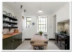  ??  ?? OLD WORLD CHARM: The kitchen sets the traditiona­l tone, with its range cooker and the large wooden butcher’s block