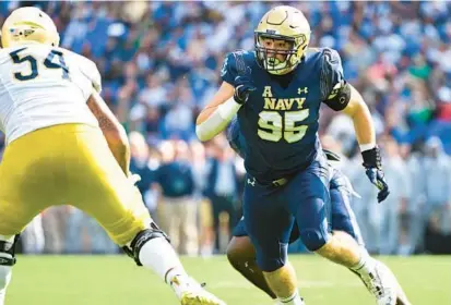  ?? TERRANCE WILLIAMS/AP ?? Navy defensive end Jacob Busic, pictured against Notre Dame on Nov. 12, 2022, in Baltimore, will transfer to UCLA.