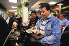  ?? AP ?? Soaring interest An Iranian shareholde­r monitors share prices on his laptop at the Tehran Stock Exchange on April 5. Money managers would rather risk of arriving too early than miss a rally.