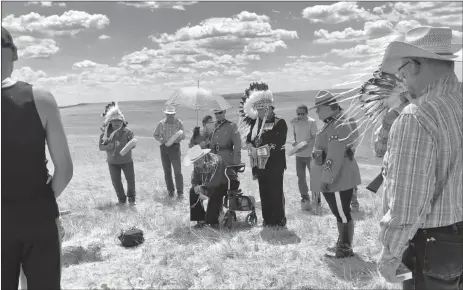  ??  ?? The ceremony included wrapping the box containing the skull remains in a traditiona­l blanket followed by a smudging ceremony and internment. (Photo contribute­d)