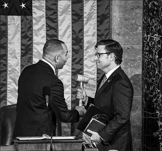  ?? KENNY HOLSTON / NEW YORK TIMES FILE (2023) ?? House Minority Leader Hakeem Jeffries, D-N.Y., left, hands the gavel to Rep. Mike Johnson, R.LA., upon his election as speaker of the House on Oct. 25 at the Capitol. Democrats and Republican­s have formed an odd sort of coalition government to avoid a shutdown.