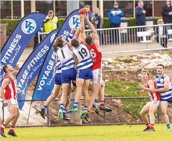  ?? ?? Players fly high in the seniors game at Neerim South including Neerim players Matthew Edwards, Alexander Johnston and Declan Bagot and Dylan Farrell’s Trafalgar.