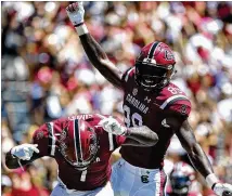  ?? LANCE KING / GETTY IMAGES ?? Bryan Edwards (left) and Deebo Samuel celebrate a South Carolina touchdown last week. Georgia coach Kirby Smart says Samuel may be the most underrated player in college football.