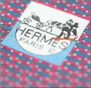 ?? FILE PHOTO: REUTERS ?? The logo of luxury goods brand Hermes on a tie. Hermes has reported improved performanc­e after years of ebbing demand in China and a slowdown in tourism in Europe.