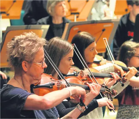  ??  ?? YOUNGSTERS from across Dundee spent the day rehearsing with the Royal Scottish National Orchestra ahead of their performanc­e of Saint Seans’ Symphony No3.
Sixty pupils from the central Music Centre programme performed as part of a showcase after...