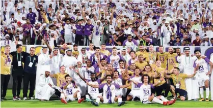  ??  ?? Al Ain players celebrate after winning the Arabian Gulf League crown at the Shabab Al Ahli Stadium in Dubai on Saturday.