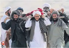  ?? REUTERS ?? Villagers carry the dead body of a child to be buried after he was killed by a gas explosion in Herat province, Afghanista­n, yesterday.