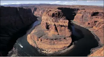  ?? MATT YORK/AP ?? WATER LEVELS AT THE COLORADO RIVER’S HORSESHOE Bend begin to rise along the beaches just hours after the Glen Canyon Dam jet tubes began releasing water, March 5, 2008, in Page, Ariz.