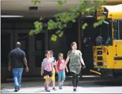  ??  ?? Students leave Roxbury Elementary School early because of the heat in Stamford on Monday.