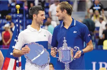  ?? JOHN MINCHILLO/ASSOCIATED PRESS ?? Novak Djokovic, of Serbia, left, and Daniil Medvedev, of Russia, talk during the trophy ceremony after the men’s singles final of the US Open on Sunday in New York. Medvedev won his first major.