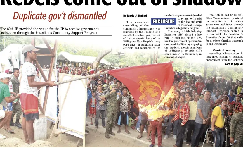  ??  ?? Going up in smoke As a former guerilla of the New People’s Army burns a flag of the communist movement during a ceremony, once solid organizati­ons in so-called NPA-influenced areas are falling apart due to defections.