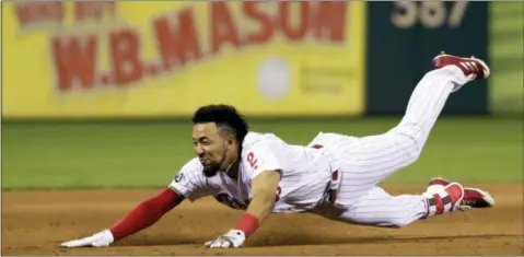  ?? MATT SLOCUM — THE ASSOCIATED PRESS ?? The Phillies’ J.P. Crawford dives to third base for a triple off Los Angeles Dodgers relief pitcher Pedro Baez during the seventh inning of a baseball game, Tuesday in Philadelph­ia. Philadelph­ia won 6-2.