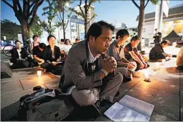  ?? AHN YOUNG-JOON/AP ?? Attendees pray at a peace service Thursday near the U.S. Embassy in Seoul, South Korea.