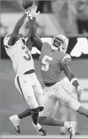  ?? Mark J. Terrill Assoiated Press ?? RAMS CORNERBACK Robert Rochell, left, breaks up a pass intended for Chargers wide receiver Joshua Palmer during the f irst half Saturday night.